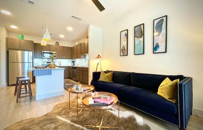 a living room and kitchen with a couch and a table