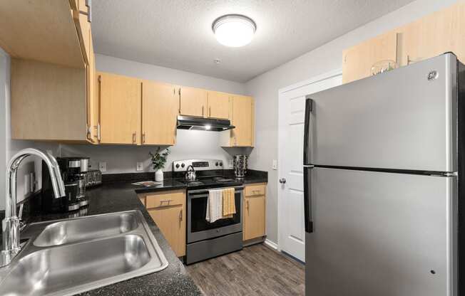 a kitchen with wood cabinets and stainless steel appliances