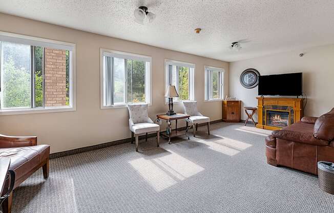 a living room with a couch and chair and a fireplace