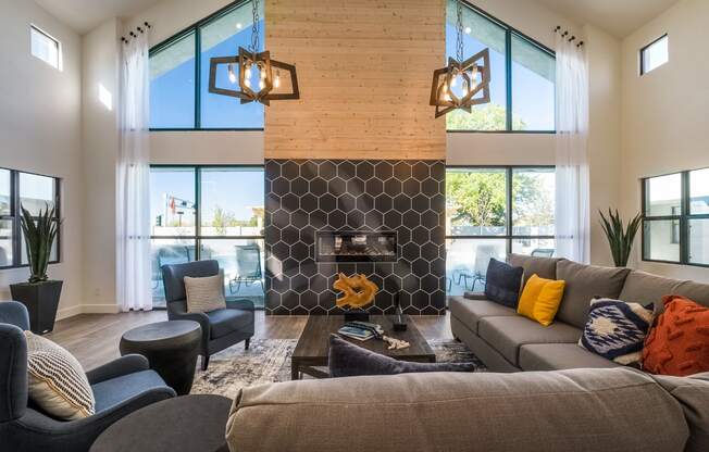 a living room with couches and chairs and a fireplace