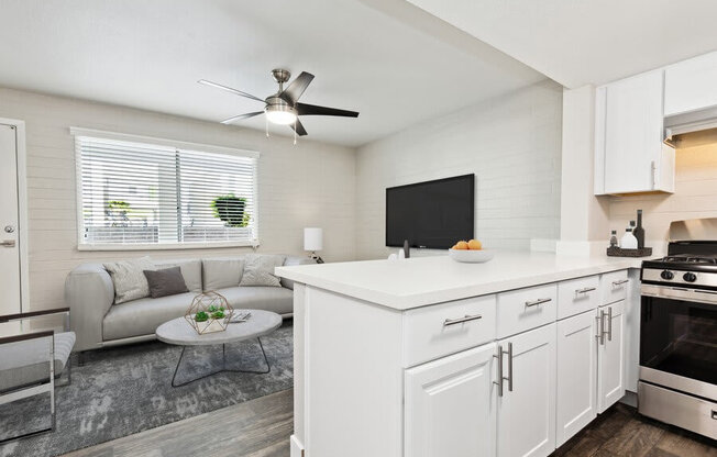 Model kitchen with bar seating and living room