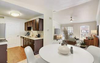 a living room and dining room with a white table and chairs