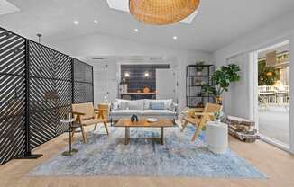 A modern living room with a black and white striped wall.