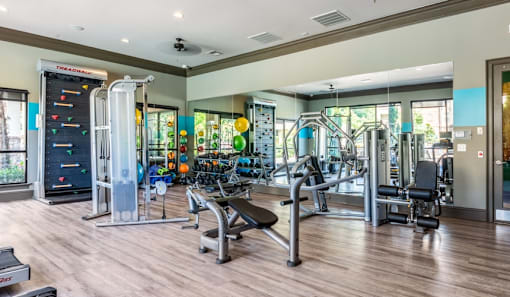 a fitness center with cardio equipment and weights in a building with glass doors  at Echo at Lake Norman, Mooresville, NC 28117