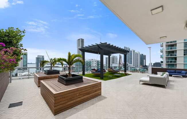 a large terrace with furniture and a pergola