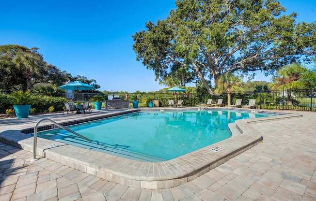 A rectangular pool with a curved edge and a brick border.
