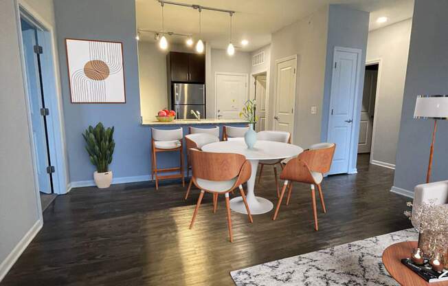 A dining room with a table set for four.