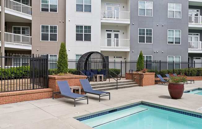 swimming pool with sundeck lounging areas at Sorelle apartments