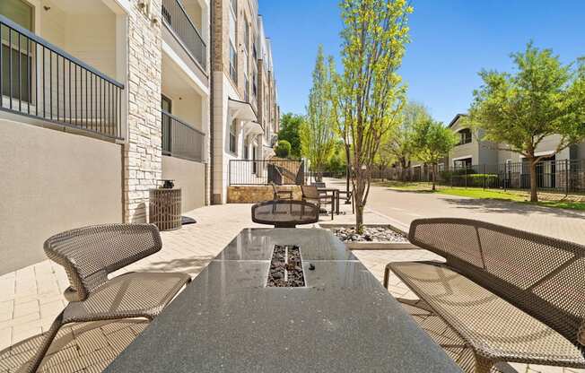 A view of a patio with a table and chairs.
