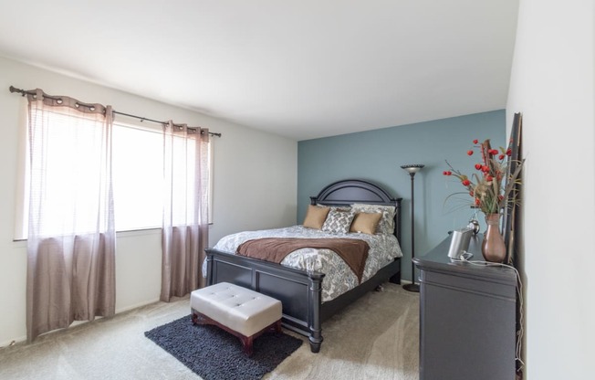 Spacious bedroom with a window in the 1 bedroom apartment at Woodbridge Apartments