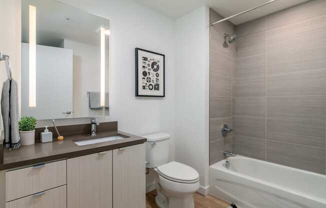 a bathroom with a toilet and a tub and a sink