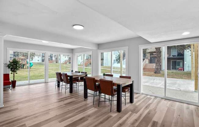 A dining room with a table and chairs.