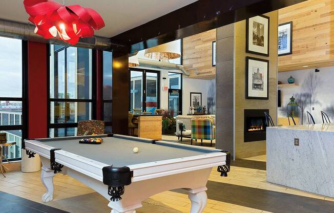 a pool table in a living room with a fireplace at Ann Arbor City Club, Michigan, 48104