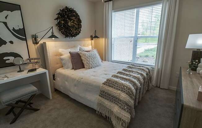 Cozy bed in bedroom with window at Abberly CenterPointe Apartment Homes, Midlothian