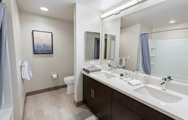 furnished bathroom with dual sinks at Bayswater Apartments, California