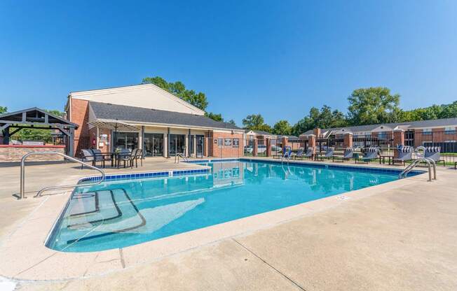 A large swimming pool in front of a building.