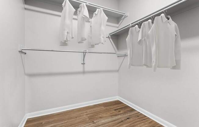 A row of white shirts hanging on a clothesline.