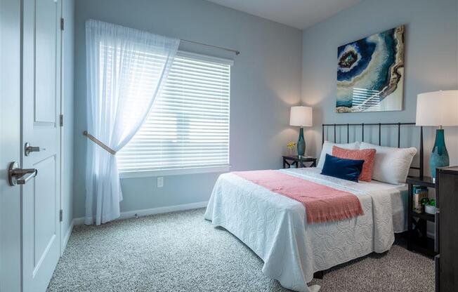 a bedroom with a bed and a window