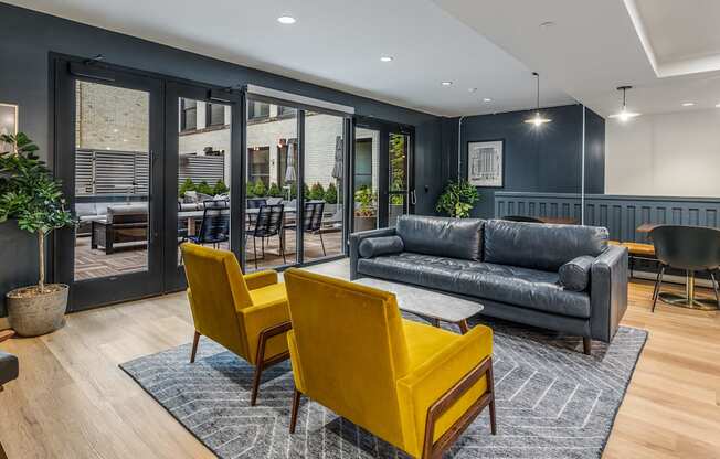 a living room with blue walls and yellow chairs and a couch at The Commonwealth Building, Pittsburgh, Pennsylvania