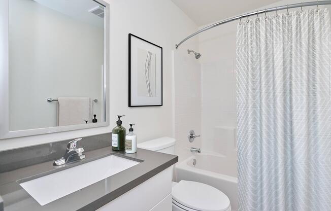 a shower curtain next to a sink