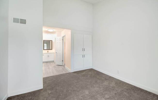 A room with white walls and a carpeted floor.