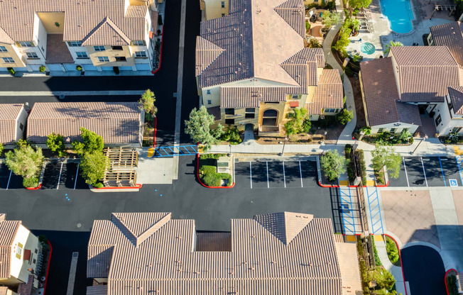 an aerial view of a neighborhood with houses and a parking lot