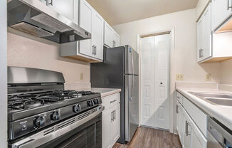 white kitchen with stainless steel appliances at West Wind Apartments in Fort Wayne, IN