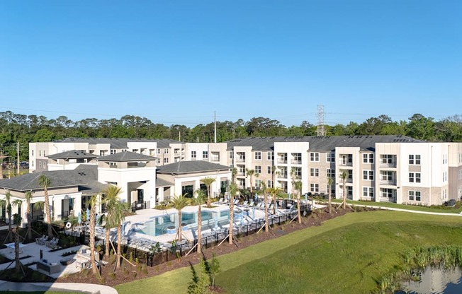 A large white building with a pool in front.