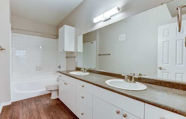 the preserve at ballantyne commons apartment bathroom with two sinks and a bath tub