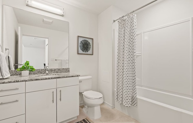 A bathroom with a toilet, sink, and bathtub.
