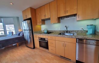 Downtown High-Rise Studio with parking and in-home laundry