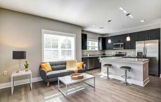 a living room with a kitchen and a couch