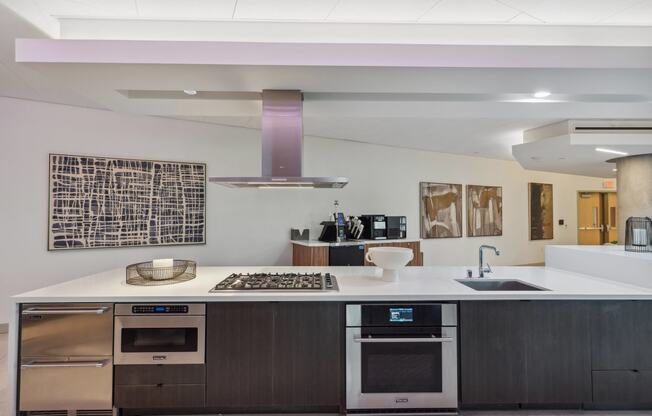 a kitchen with a white counter top and stainless steel appliances