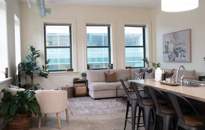 a living room and dining room with a table and chairs