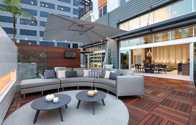 a living room with a couch and tables on a patio
