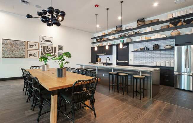 Studio Apartments in Downtown Berkeley, CA - The Addison - Private Dining Area With A Catering Kitchen, Stainless Steel Refrigerator, Chairs, Table, Stove, And Island