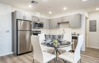 Dining area with wood style flooring, open Gourmet Kitchen, recessed lighting