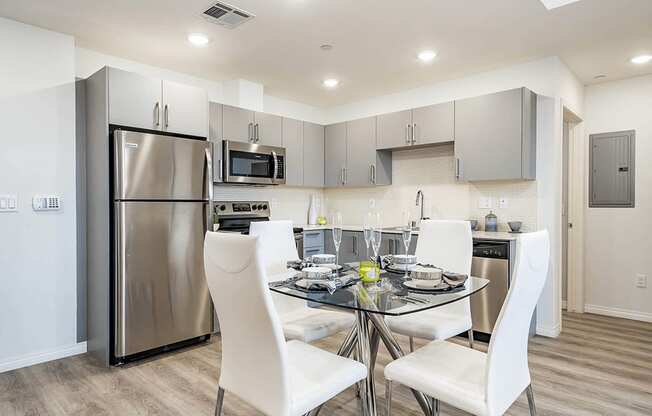 Dining area with wood style flooring, open Gourmet Kitchen, recessed lighting