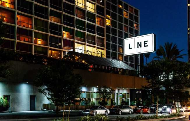 a large white sign that says line in front of a tall building