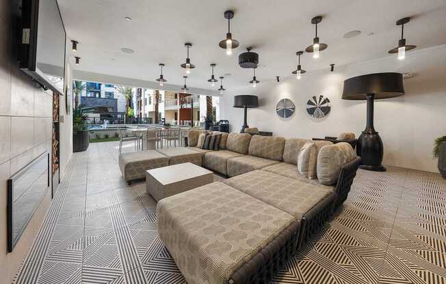 A large sectional sofa with a chaise lounge is in the middle of a room with a patterned floor.