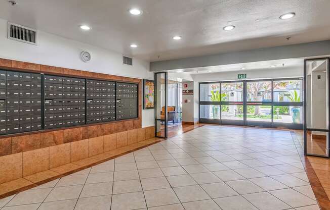 a locker room in a school with a tiled floor and a glass door with a view