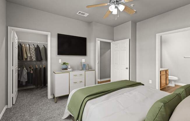 A bedroom with a bed, dresser, and a television.