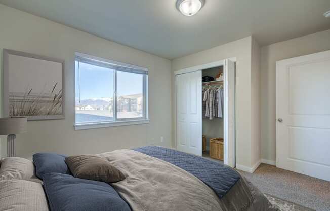 a bedroom with a bed and a closet and a window  at Madison Park, Bozeman, 59718