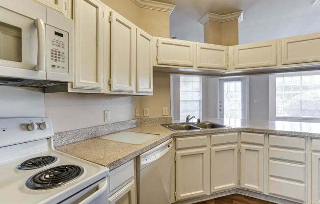 Large kitchens with ample storage space at Turnberry Isle Apartments in Dallas, TX.