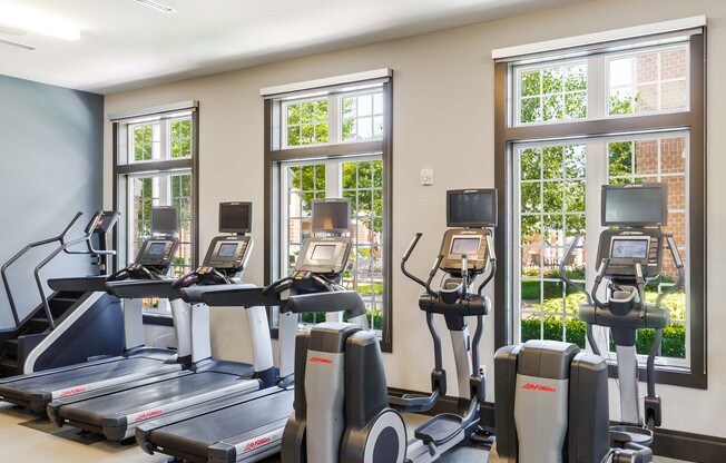 A gym with treadmills and exercise bikes.