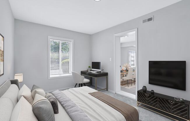 a bedroom with a bed and a tv