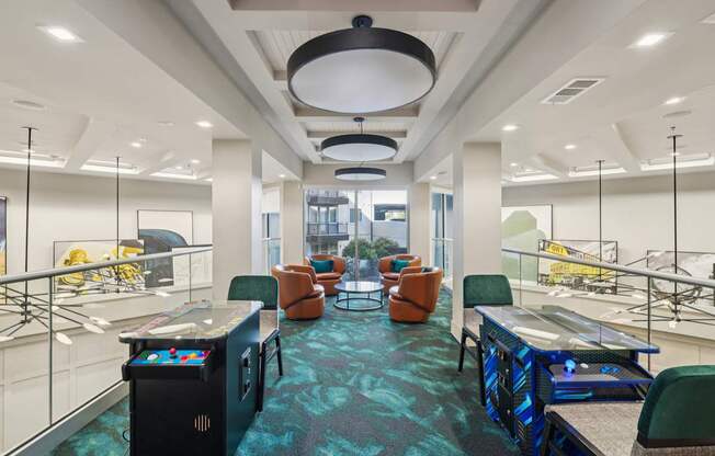 A modern office space with a blue carpet and various seating arrangements.