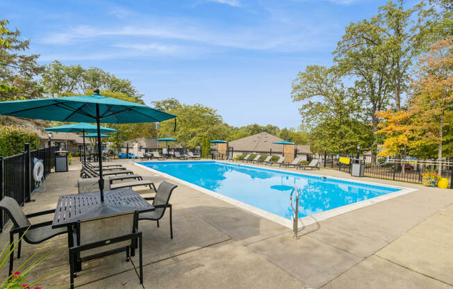 our apartments have a swimming pool with chairs and tables