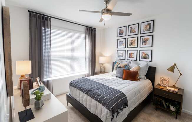 a bedroom with a bed and a ceiling fan