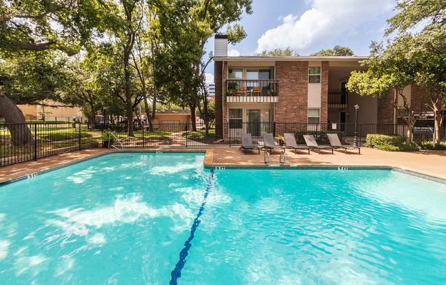 This is a photo of the pool area at Preston Park Apartments in Dallas, TX